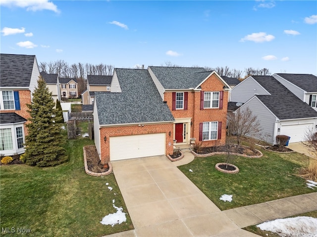 view of front of property with a garage and a front lawn