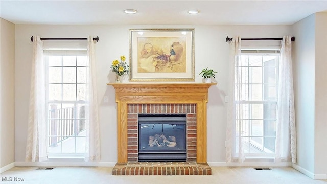 details featuring a brick fireplace and carpet