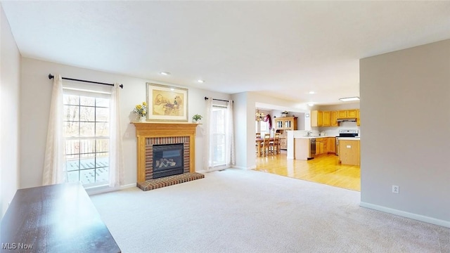 living room featuring a fireplace and light colored carpet