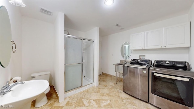 laundry area featuring independent washer and dryer and sink