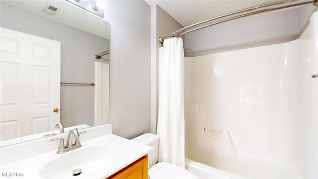 full bathroom with vanity, toilet, and shower / bath combo with shower curtain