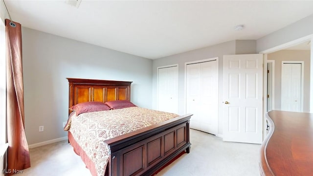 carpeted bedroom with two closets