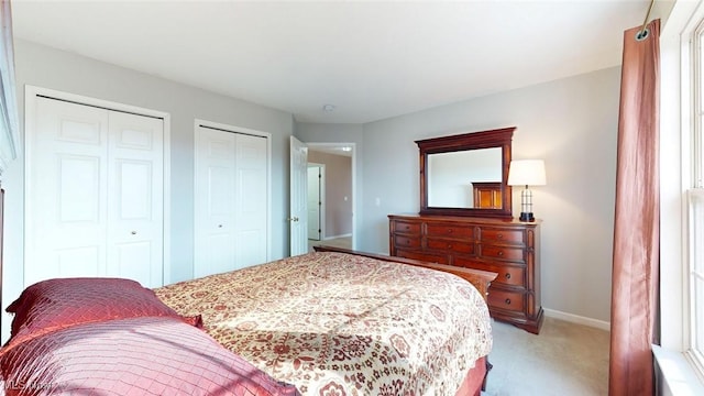 carpeted bedroom with multiple closets