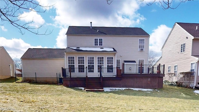 back of house with a wooden deck and a lawn