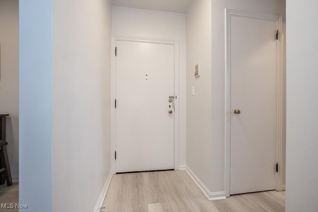 corridor with light hardwood / wood-style floors