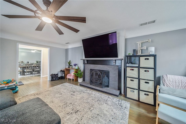 living room featuring hardwood / wood-style floors and ceiling fan