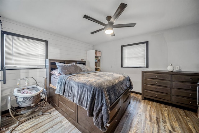 bedroom featuring dark hardwood / wood-style flooring and ceiling fan