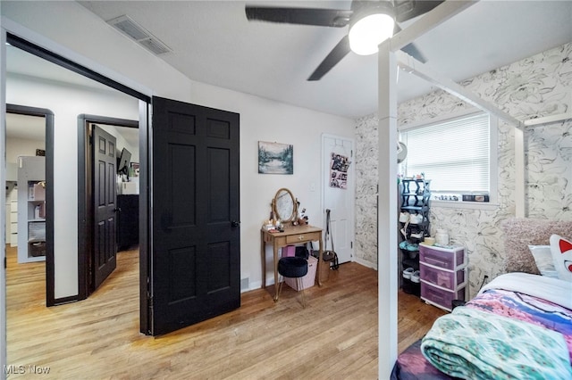 bedroom with ceiling fan and light hardwood / wood-style flooring