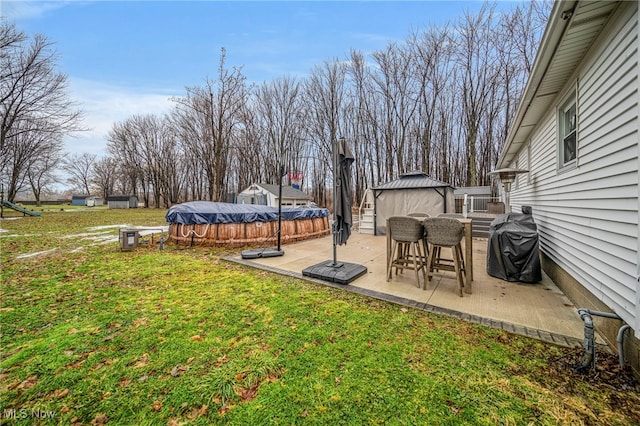 view of yard with a gazebo, a covered pool, and a patio