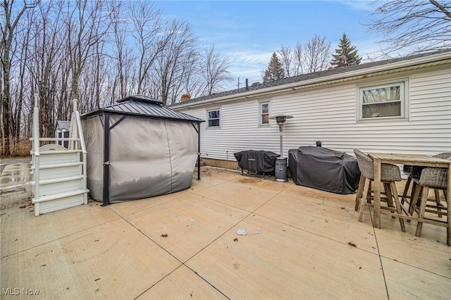 exterior space with a gazebo and a grill