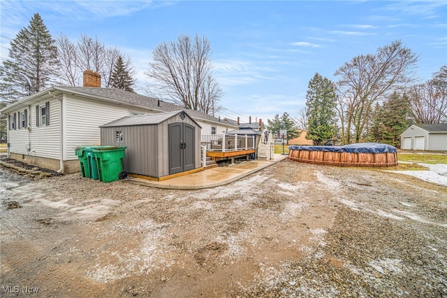 view of yard with a covered pool and a shed