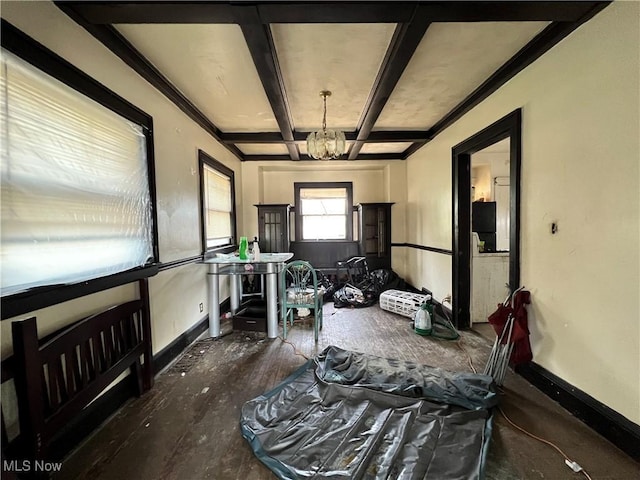 interior space with crown molding, coffered ceiling, a chandelier, and beam ceiling