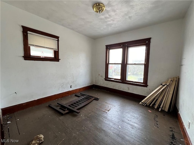 spare room featuring dark wood-type flooring