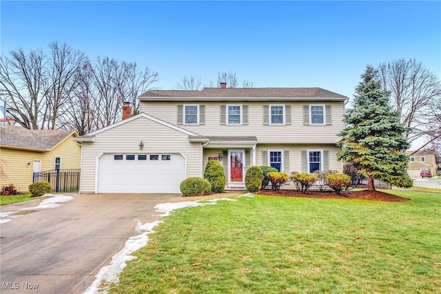 view of front of home featuring a garage and a front lawn