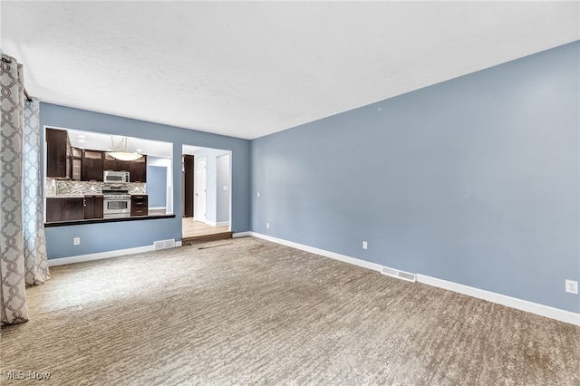 unfurnished living room featuring carpet flooring