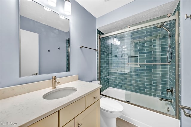 full bathroom with vanity, toilet, and combined bath / shower with glass door