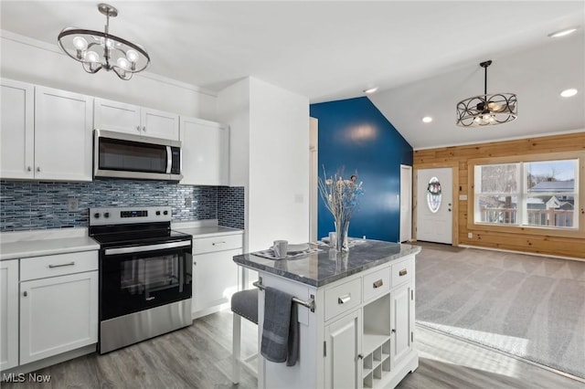 kitchen with white cabinetry, appliances with stainless steel finishes, and pendant lighting