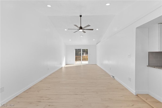 interior space featuring ceiling fan, vaulted ceiling, and light hardwood / wood-style flooring