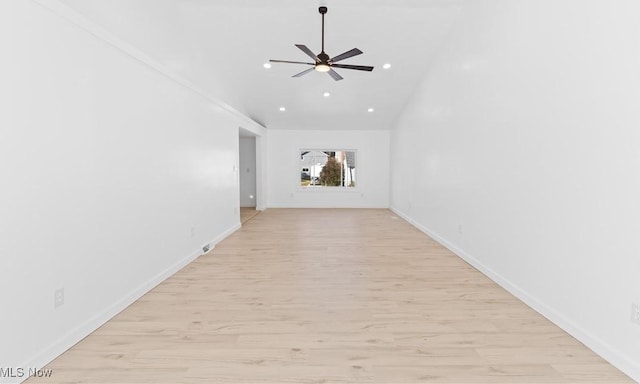 interior space featuring ceiling fan, vaulted ceiling, and light wood-type flooring