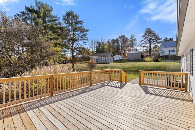 deck with a yard and a shed