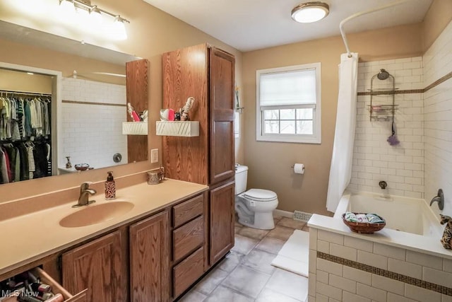 full bathroom featuring shower / tub combo with curtain, vanity, tile patterned flooring, and toilet