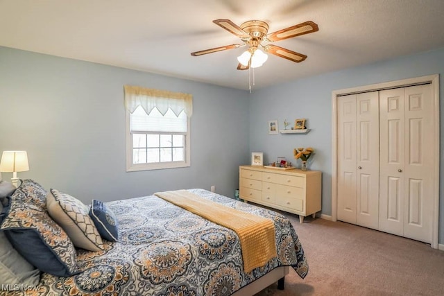 carpeted bedroom featuring a closet and ceiling fan