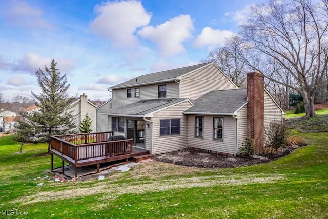 back of house featuring a wooden deck and a lawn