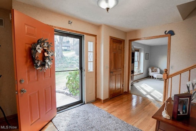 foyer featuring plenty of natural light and light hardwood / wood-style flooring