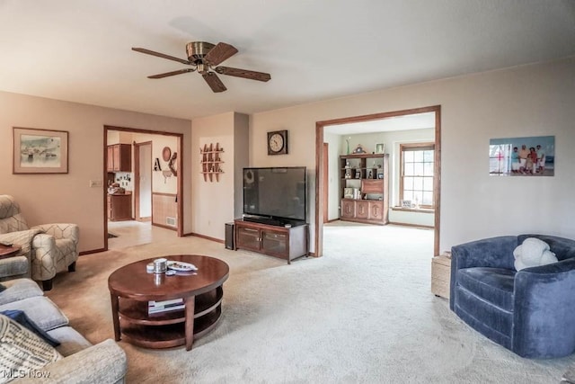 carpeted living room featuring ceiling fan