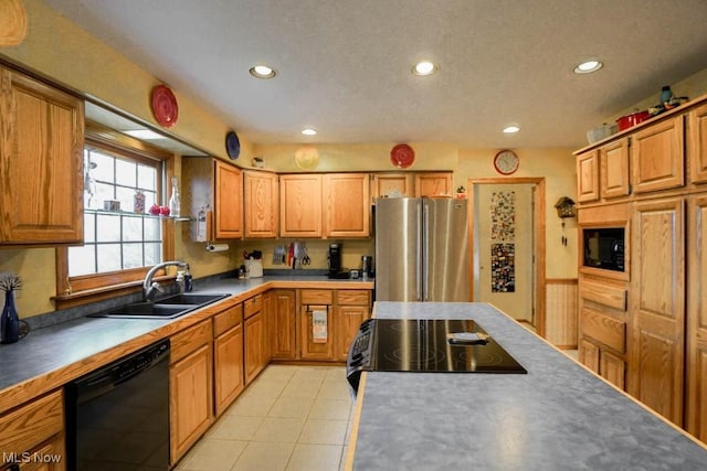 kitchen featuring light tile patterned floors, sink, and black appliances