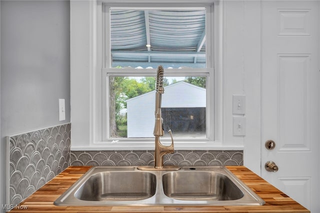 room details featuring sink and decorative backsplash