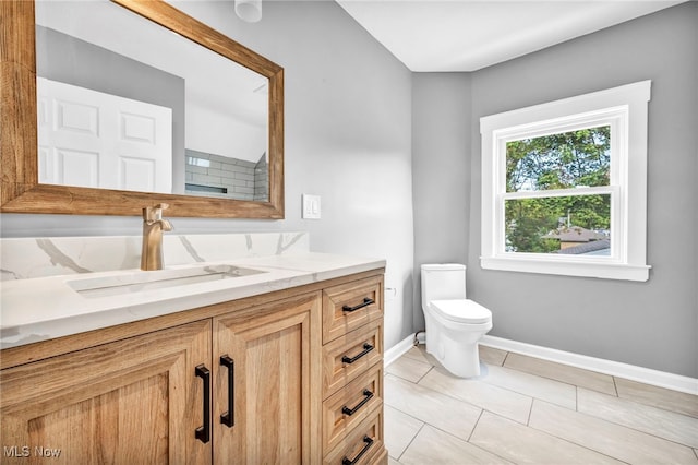 bathroom featuring vanity, toilet, and tile patterned flooring