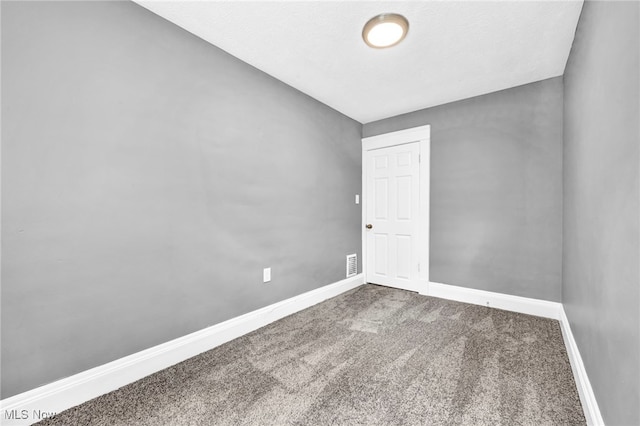 empty room with carpet flooring