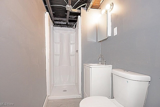 bathroom featuring sink, brick ceiling, toilet, and walk in shower