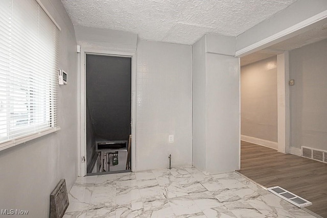 interior space featuring a textured ceiling