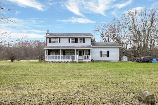 view of front of home with a porch, a storage shed, and a front lawn