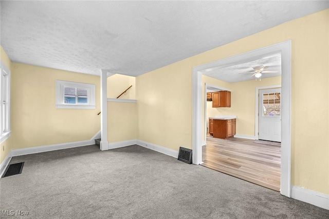 empty room with carpet floors and a textured ceiling