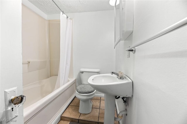 full bathroom with toilet, sink, a textured ceiling, shower / bath combination with curtain, and tile patterned flooring