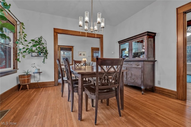 dining room with an inviting chandelier and light wood-type flooring