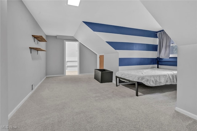 unfurnished bedroom with vaulted ceiling and carpet