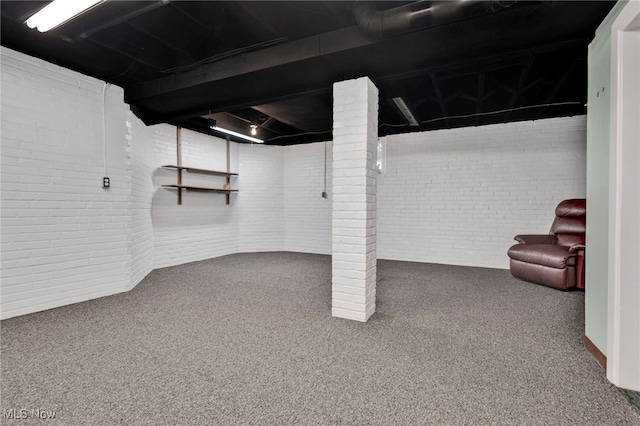 basement with brick wall and carpet