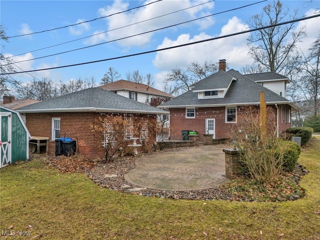 back of property featuring a lawn and a patio area