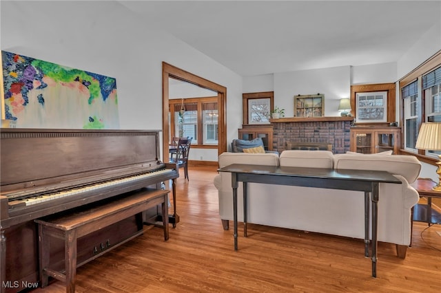 living room with a fireplace and light wood-type flooring