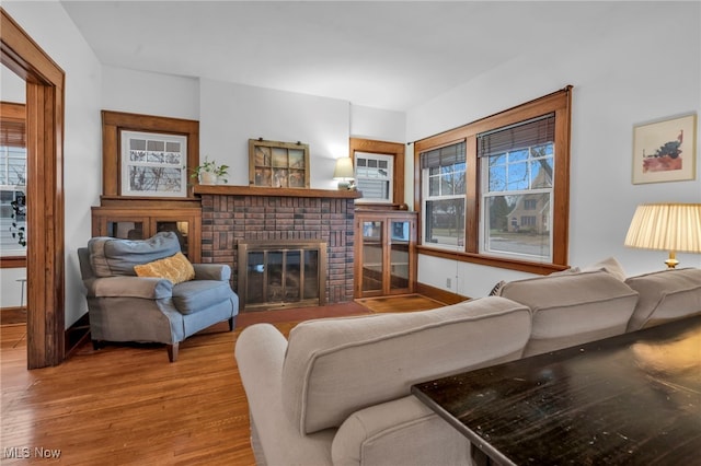 living room featuring a wealth of natural light, hardwood / wood-style floors, and a fireplace