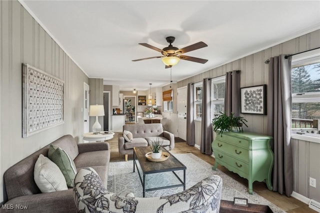 living room featuring crown molding and ceiling fan