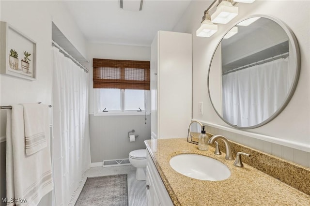 bathroom with vanity, toilet, and tile patterned flooring