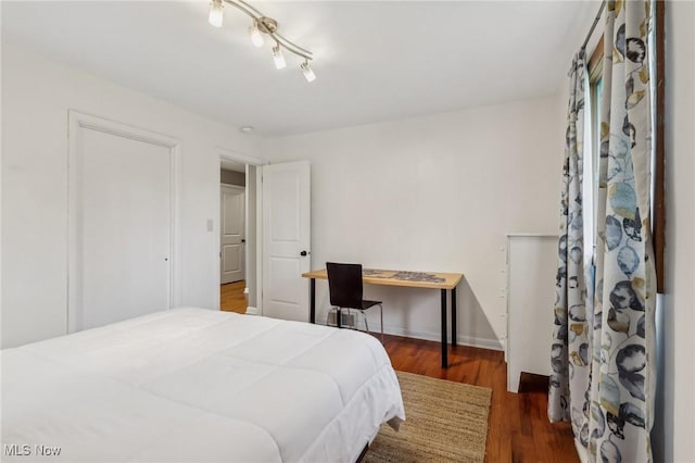 bedroom featuring dark hardwood / wood-style flooring