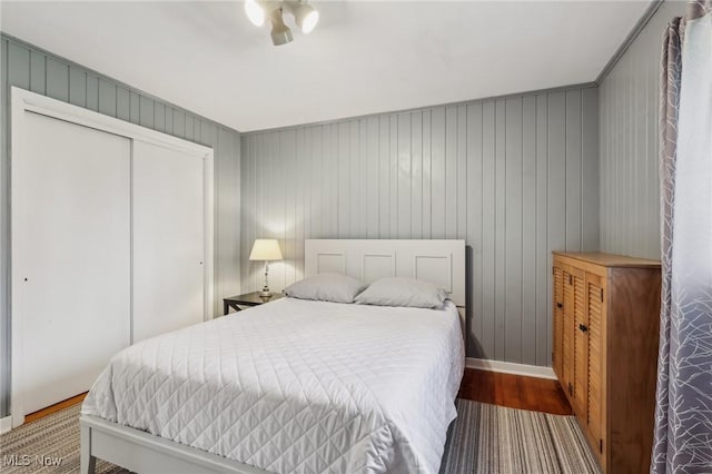 bedroom with wood-type flooring and a closet