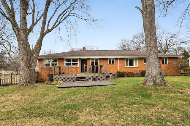 rear view of property featuring a yard and a deck