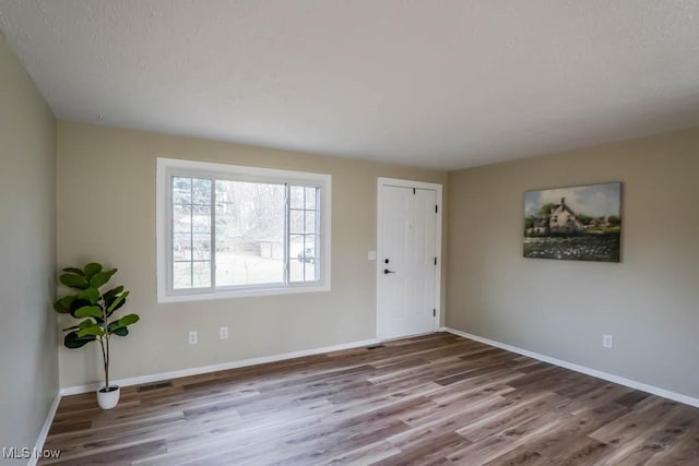 spare room featuring hardwood / wood-style floors